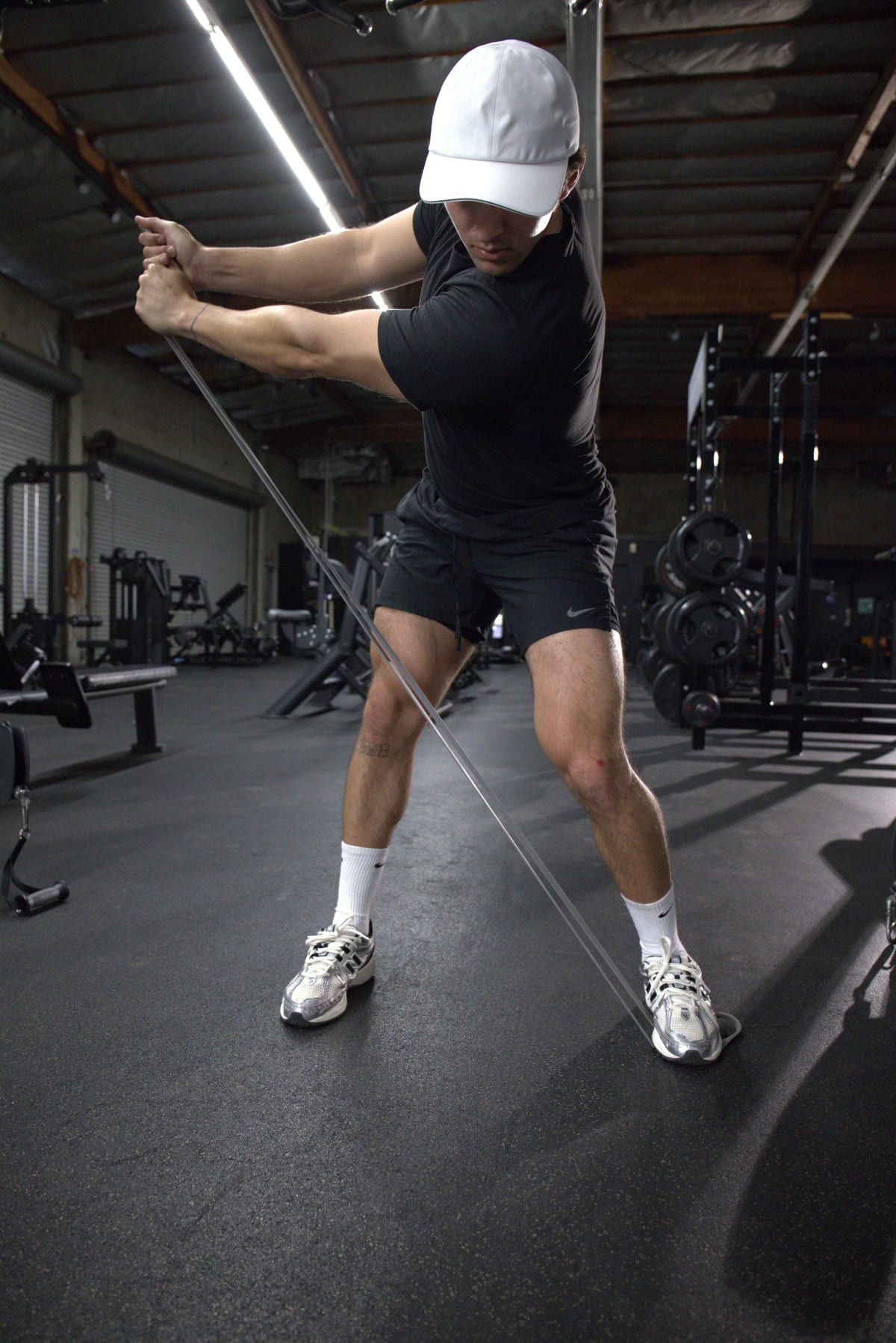 Golf Fit athlete in a braced resistance-band rotational pull, building strength and endurance